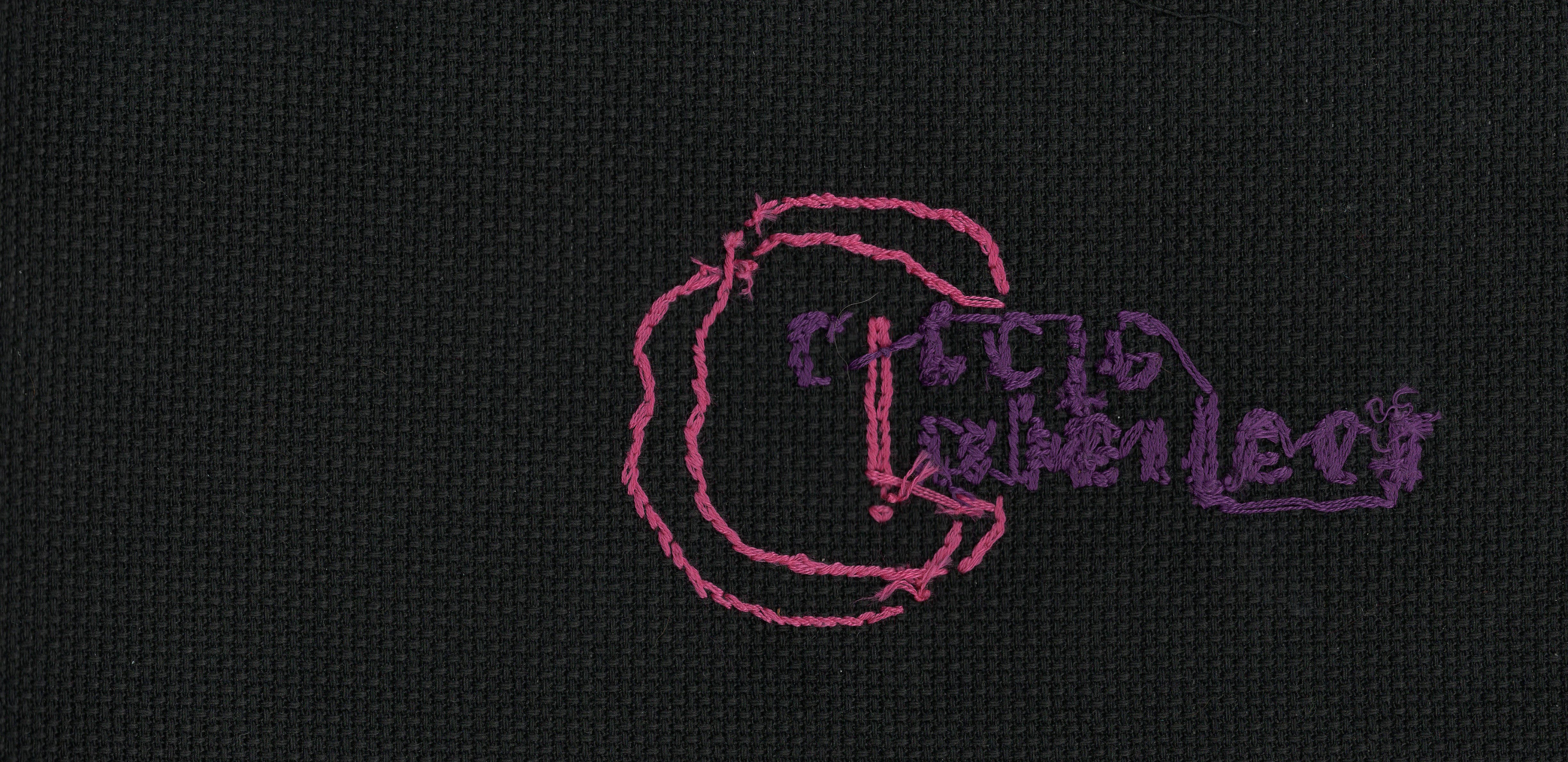 The backside of the cross-stitched banner, showing threads