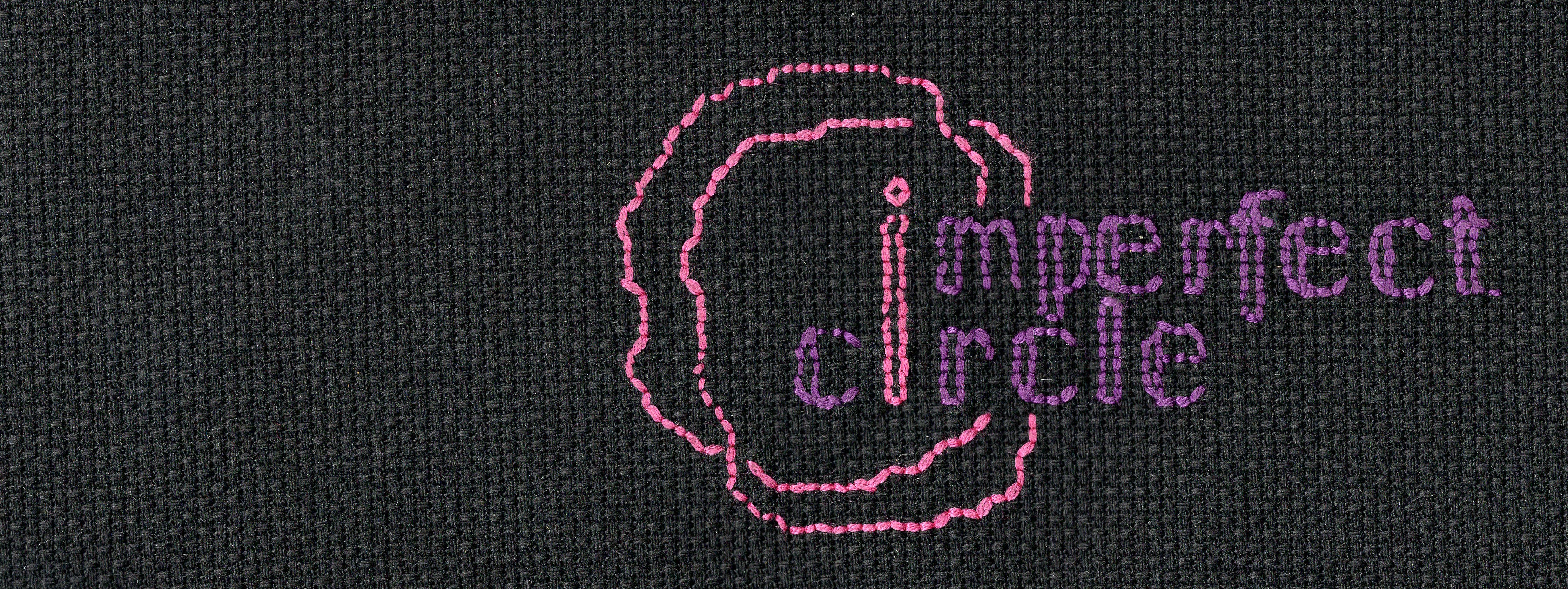 A cross-stitched banner image: black background, purple text, pink i and squiggly twin halo remeniscent of the flaming chalice